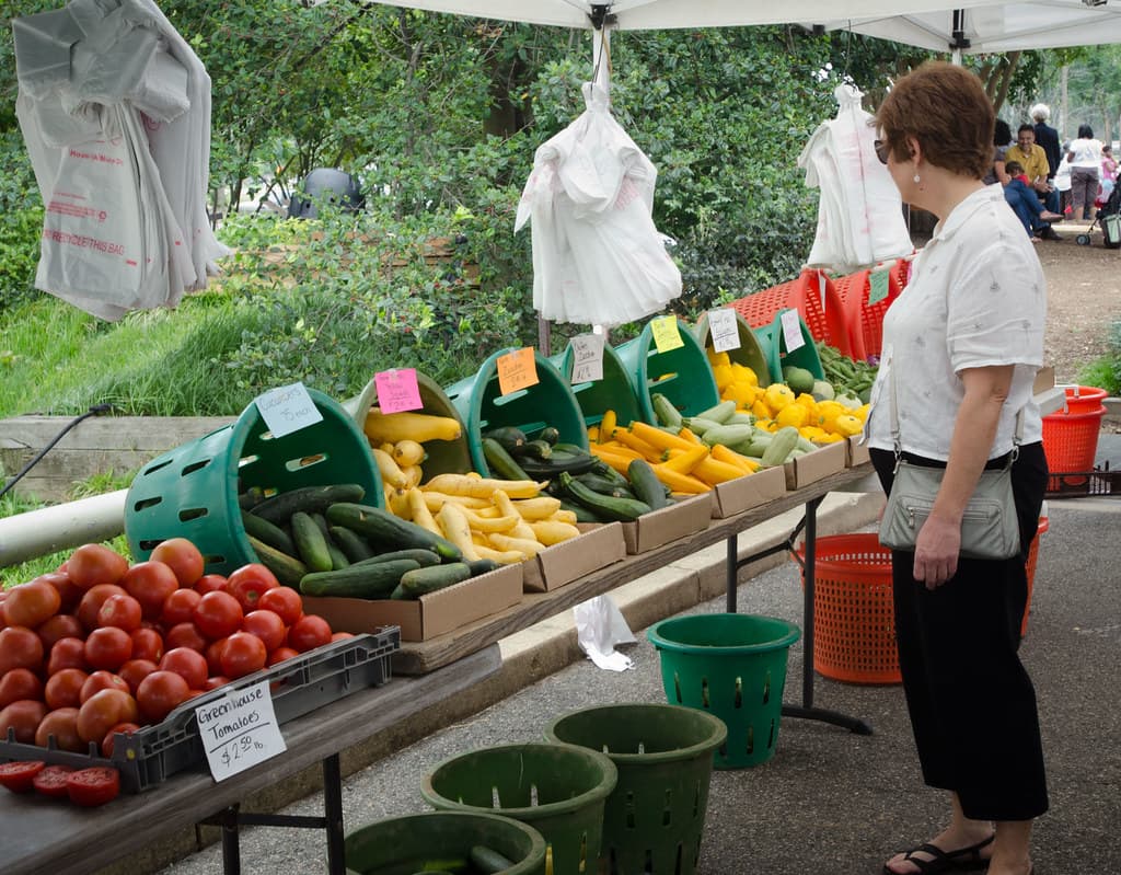 Shoppers browsing fresh produce at a farmers market